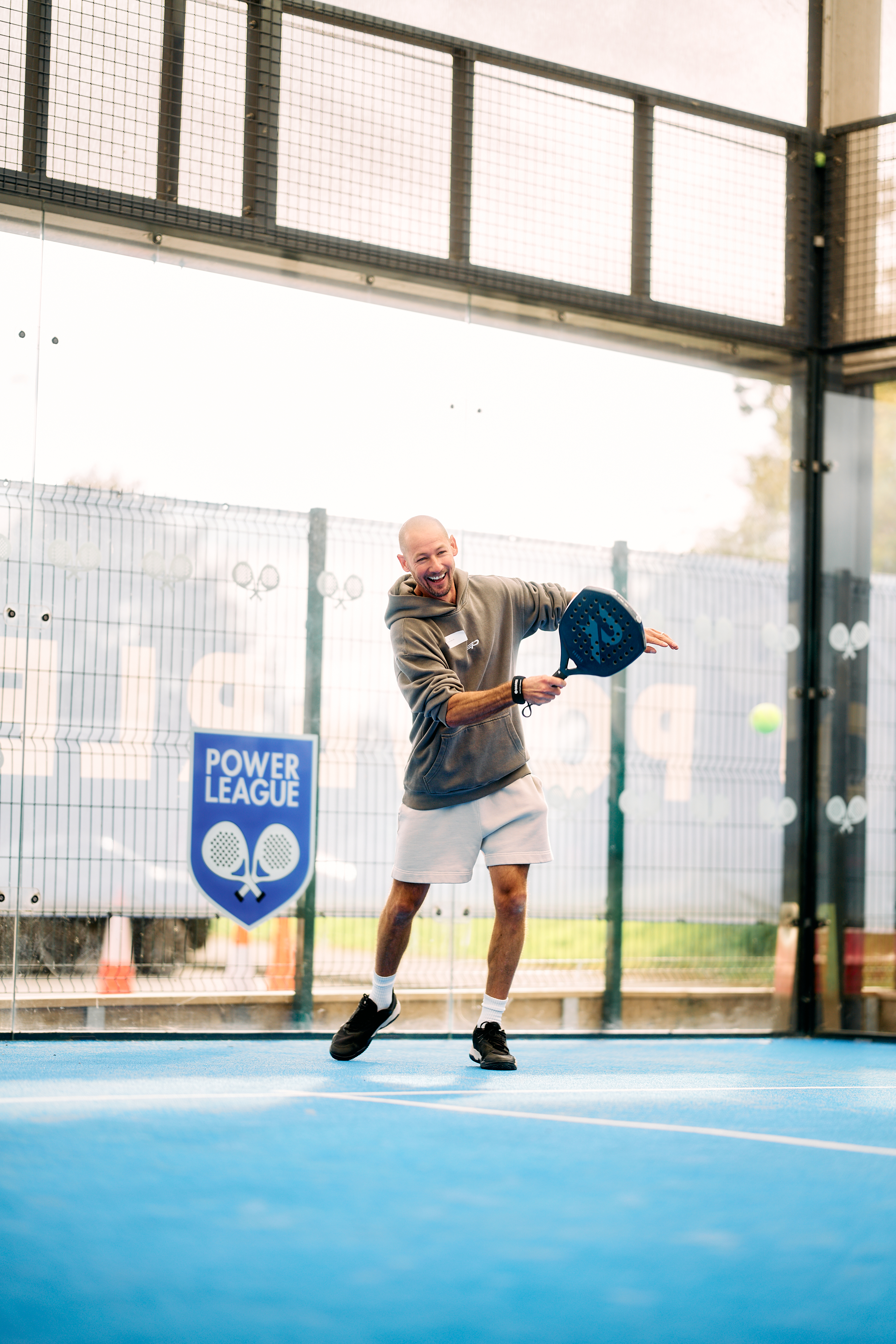 Player laughing while hitting a backhand