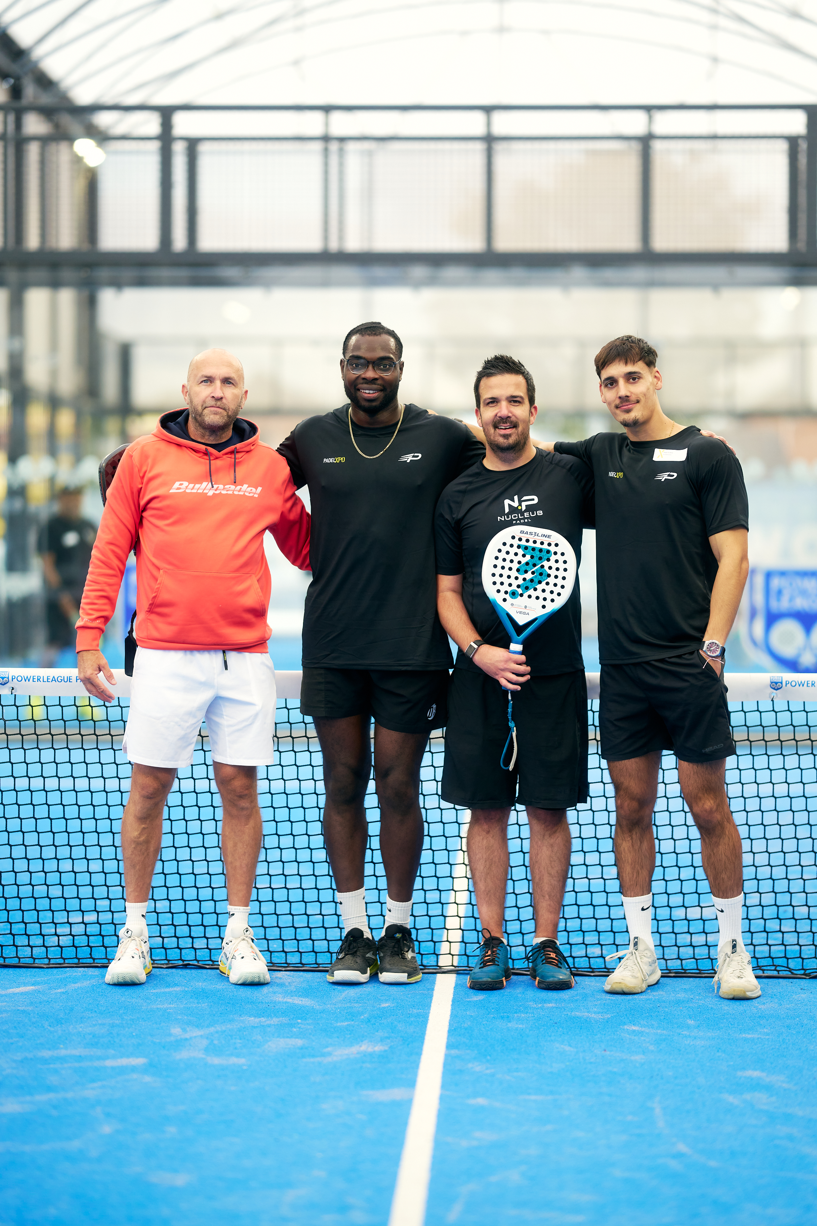 Four players posing together at the net